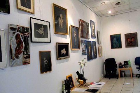 Galeriewand mit zahlreichen gerahmten Arbeiten